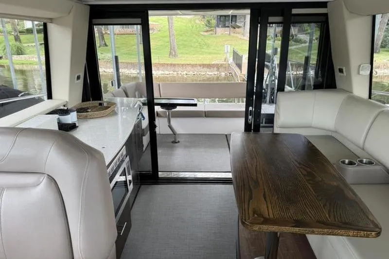 Slide: The Image of Interior of 2017 Regal 42 Grande Coupe yacht with modern seating and dining area. - 21