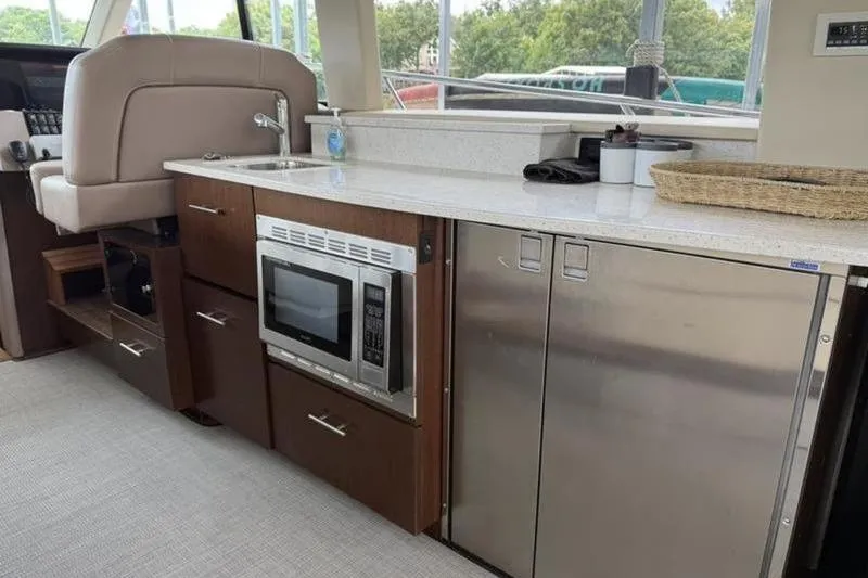 Slide: The Image of Interior of 2017 Regal 42 Grande Coupe yacht with kitchenette and appliances. - 24