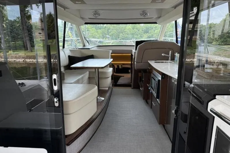 Slide: The Image of Interior of 2017 Regal 42 Grande Coupe yacht with modern seating and kitchen area. - 28