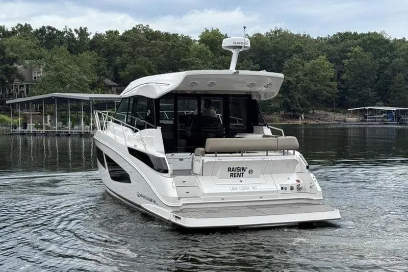 Slide: The Image of 2017 Regal 42 Grande Coupe yacht on a lake with wooded shoreline. - 4