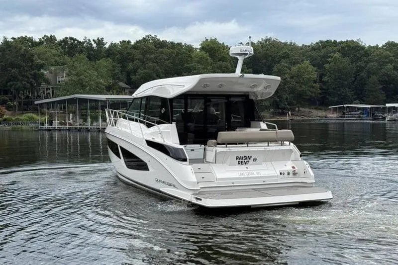 Slide: The Image of 2017 Regal 42 Grande Coupe yacht cruising on a serene lake. - 6