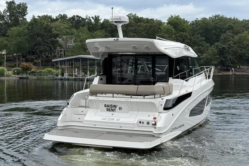 Slide: The Image of 2017 Regal 42 Grande Coupe yacht on a lake, rear view. - 9