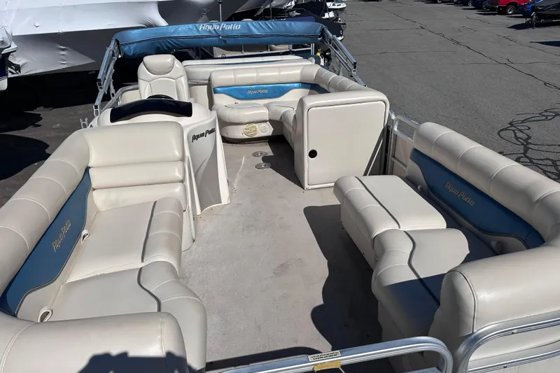 Slide: The Image of 2007 AquaPatio AP 180 RE-3 Gate pontoon boat with spacious seating and blue accents. - 2