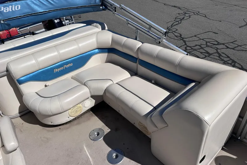 Slide: The Image of 2007 AquaPatio AP 180 RE-3 Gate boat interior with white and blue seating. - 5