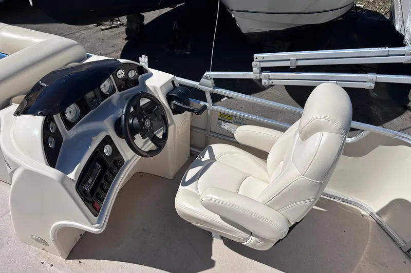 Slide: The Image of 2007 AquaPatio AP 180 RE-3 Gate boat helm with steering wheel and gauges. - 6