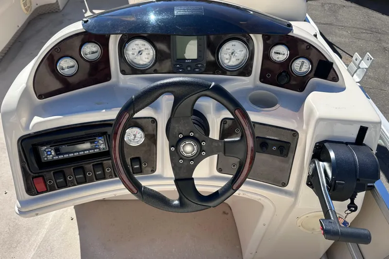 Slide: The Image of 2007 AquaPatio AP 180 RE-3 Gate boat dashboard with steering wheel and controls. - 7