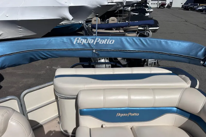 Slide: The Image of 2007 AquaPatio AP 180 RE-3 Gate pontoon boat with blue and white seating. - 8