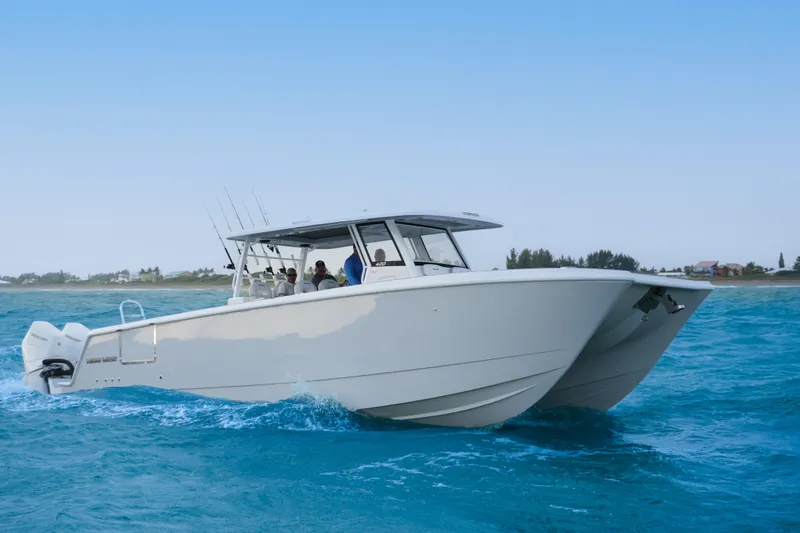 The Image of 2025 Twin Vee 400 GFX2 CC catamaran cruising on blue ocean waters. - 0