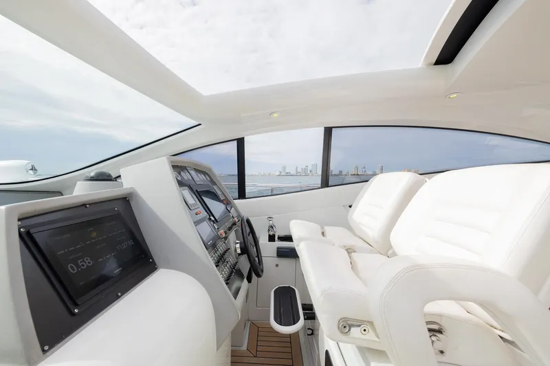 Slide: The Image of Luxurious interior of a 2007 Pershing 56 yacht with modern dashboard and white seating. - 11