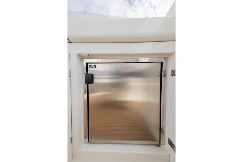Slide: The Image of Stainless steel compartment door on 2007 Pershing 56 yacht, reflecting light. - 13
