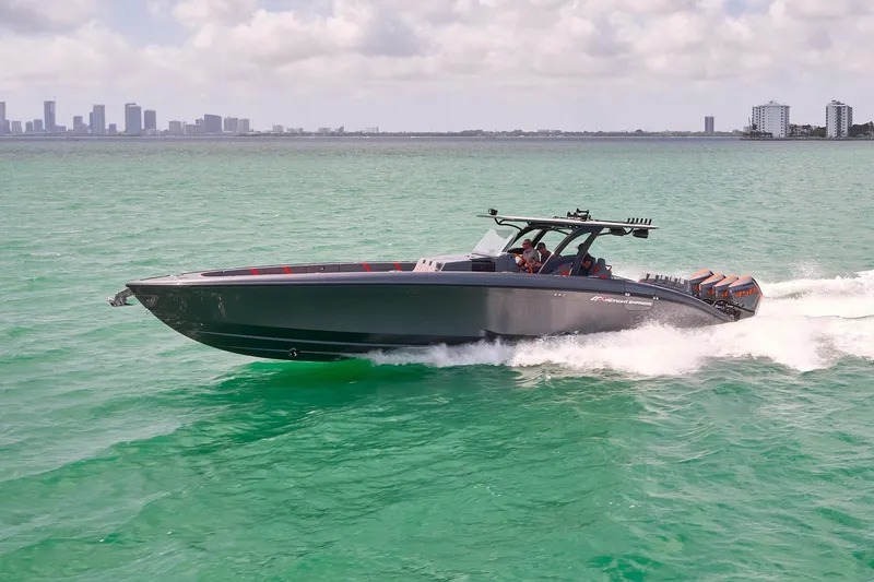 The Image of 2022 Midnight Express 43 Open boat cruising on turquoise water near city skyline. - 0