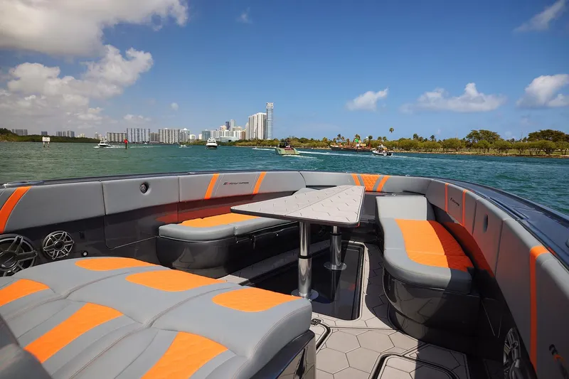 Slide: The Image of 2022 Midnight Express 43 Open boat interior with orange accents on a sunny day. - 10
