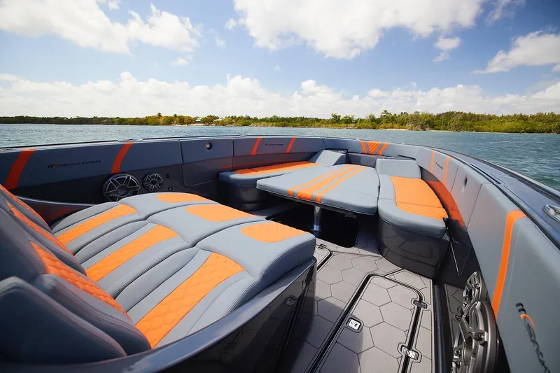 Slide: The Image of Luxurious 2022 Midnight Express 43 Open boat interior with orange and gray seating on a sunny day. - 11