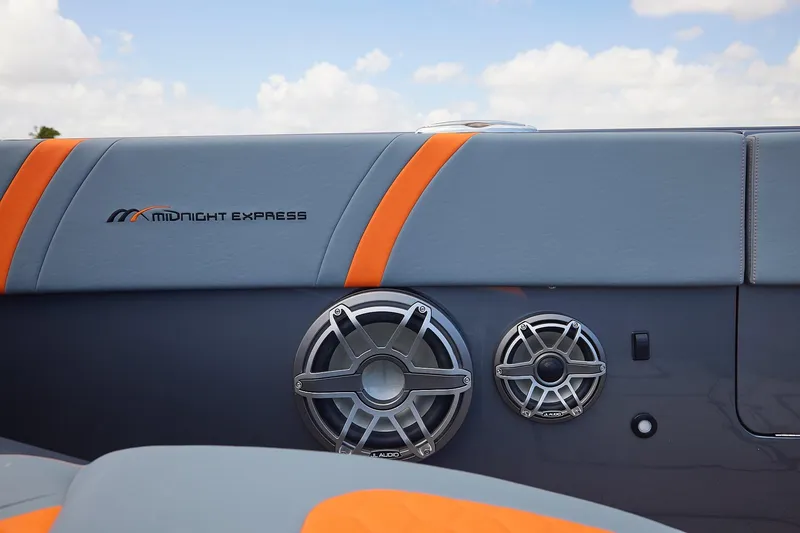 Slide: The Image of 2022 Midnight Express 43 Open boat interior with speakers and orange accents. - 12