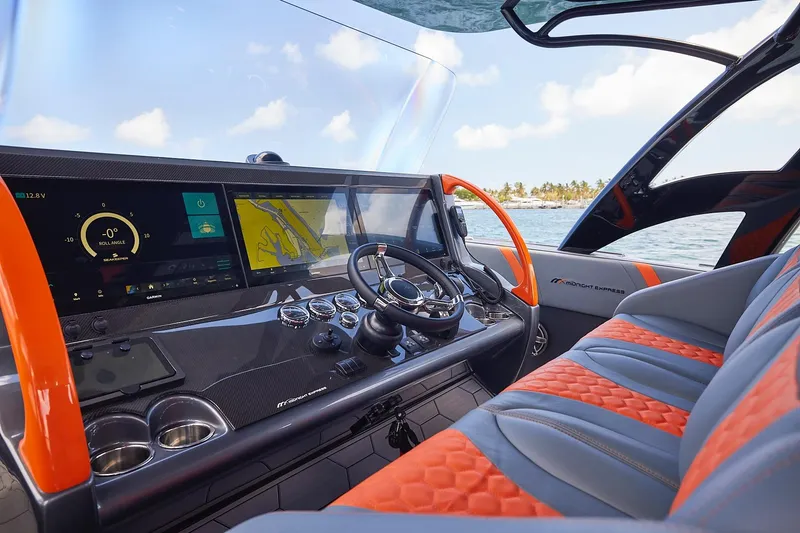 Slide: The Image of Cockpit of 2022 Midnight Express 43 Open boat with advanced navigation displays and luxurious seating. - 13