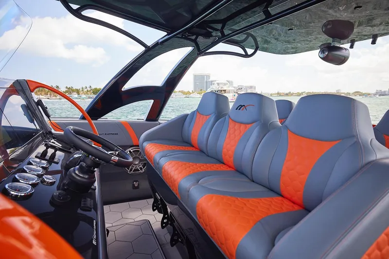 Slide: The Image of Luxurious interior of 2022 Midnight Express 43 Open boat with orange and gray seating. - 14