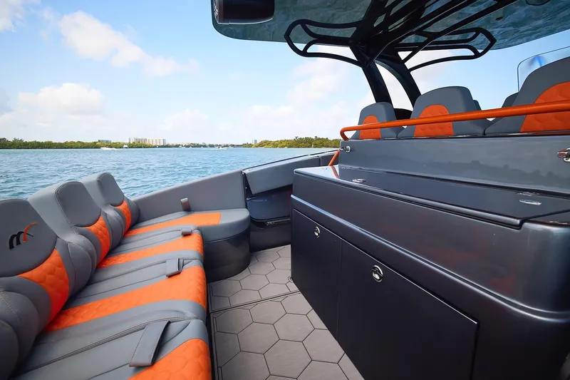 Slide: The Image of Luxurious 2022 Midnight Express 43 Open boat interior with orange and gray seating on the water. - 15