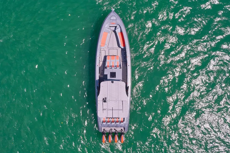 Slide: The Image of Aerial view of 2022 Midnight Express 43 Open boat on vibrant green water. - 3