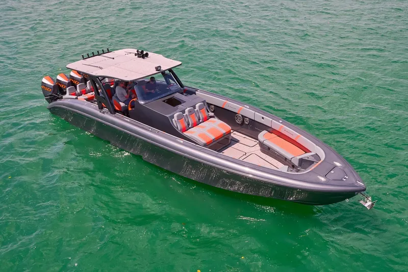 Slide: The Image of 2022 Midnight Express 43 Open boat on clear green water, featuring sleek design and powerful engines. - 4