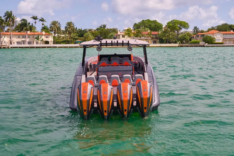 Slide: The Image of 2022 Midnight Express 43 Open boat with four powerful engines on turquoise water. - 6