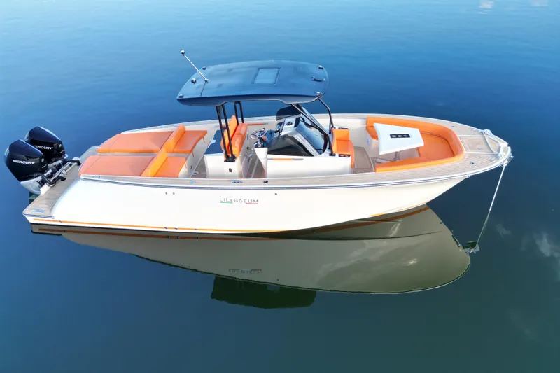 The Image of 2026 Lilybaeum Lipari 31 boat with orange seating, dual Mercury engines, on calm water. - 0