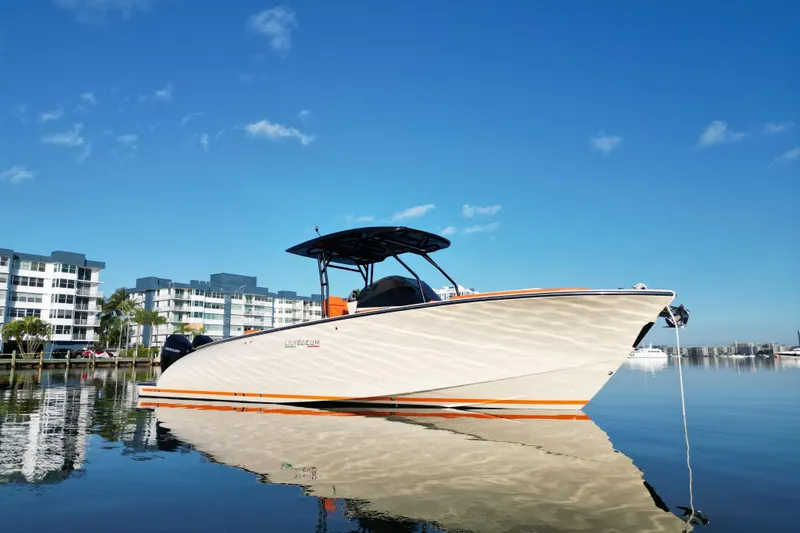 Slide: The Image of 2026 Lilybaeum Lipari 31 boat docked on calm water, modern buildings in background. - 10