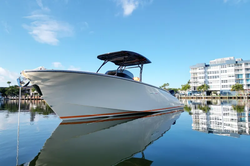 Slide: The Image of 2026 Lilybaeum Lipari 31 boat docked on calm water, modern building in background. - 13