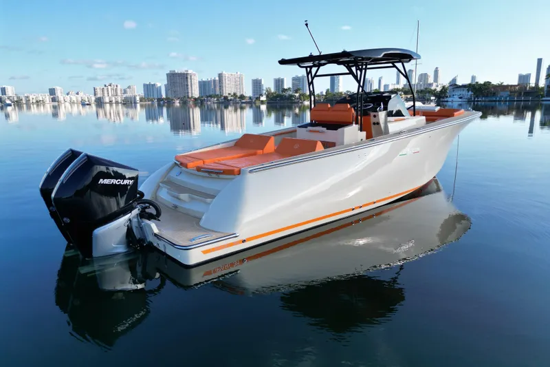 Slide: The Image of Lilybaeum Lipari 31 boat, 2026 model, on calm water with city skyline background. - 32