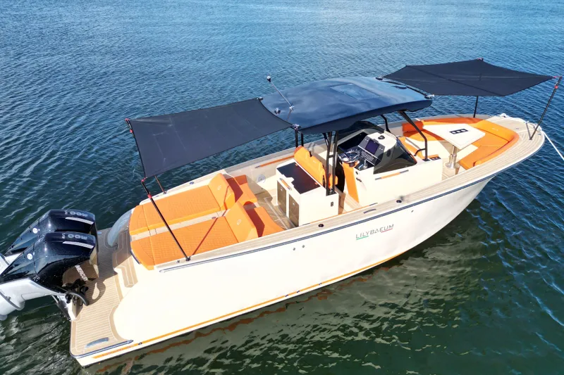 Slide: The Image of 2026 Lilybaeum Lipari 31 boat with orange seating and dual engines on water. - 33