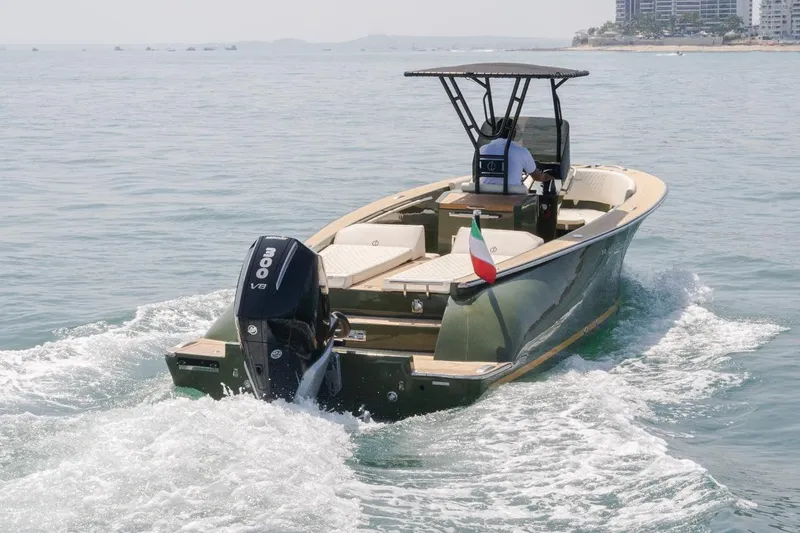 Slide: The Image of 2026 Lilybaeum Levanzo 25 Lounge Deck boat cruising on open water with Italian flag. - 13