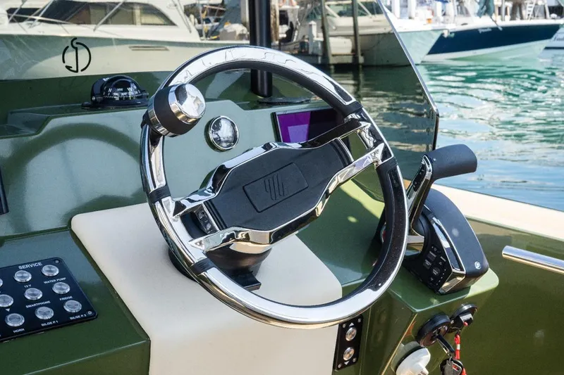 Slide: The Image of Steering wheel of 2026 Lilybaeum Levanzo 25 Lounge Deck boat at marina. - 5