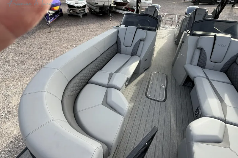 Slide: The Image of Luxurious interior of 2022 Manitou 27 LX SRW pontoon boat with plush seating. - 10