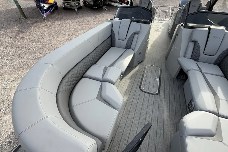Slide: The Image of Luxurious interior of 2022 Manitou 27 LX SRW pontoon boat with plush seating. - 11