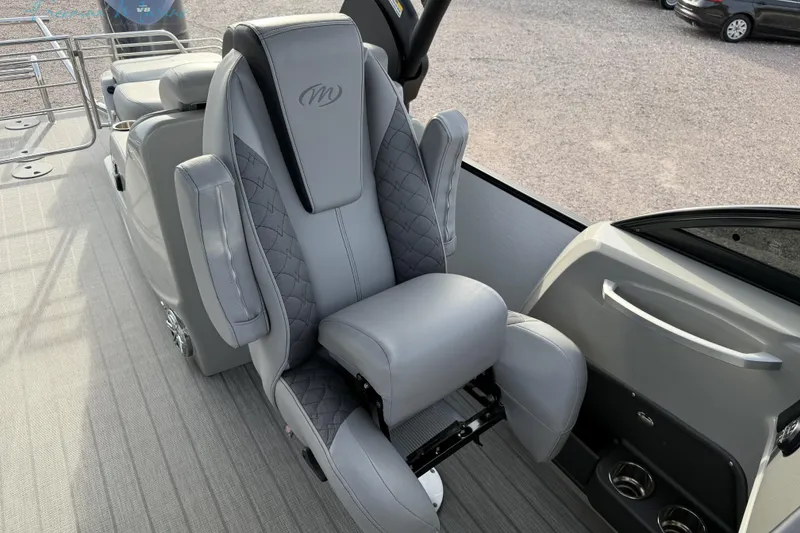 Slide: The Image of Luxurious seating on 2022 Manitou 27 LX SRW boat, featuring premium gray upholstery. - 14