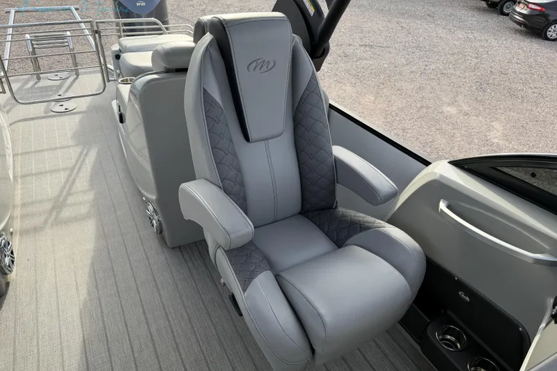 Slide: The Image of Luxurious seating on 2022 Manitou 27 LX SRW boat, featuring elegant gray upholstery. - 15