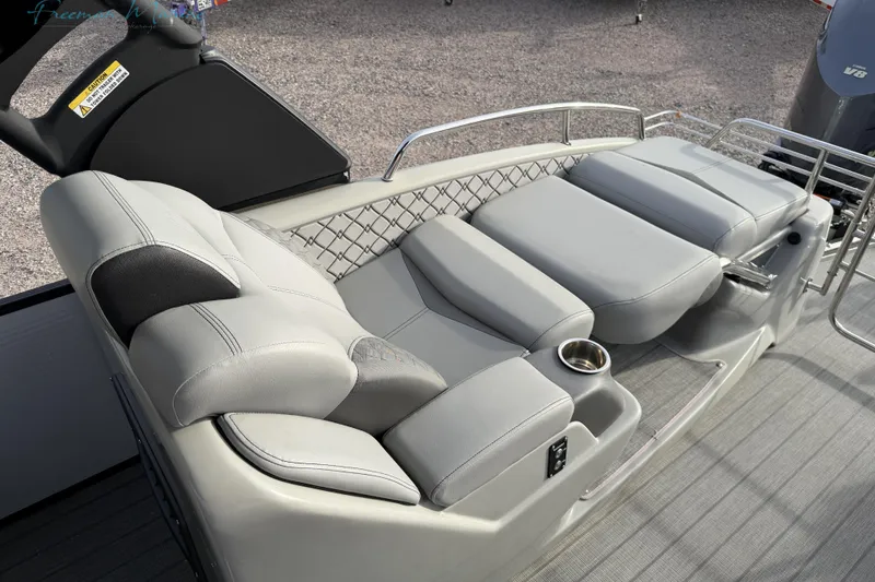 Slide: The Image of Luxurious seating on 2022 Manitou 27 LX SRW boat with cup holder and sleek design. - 19