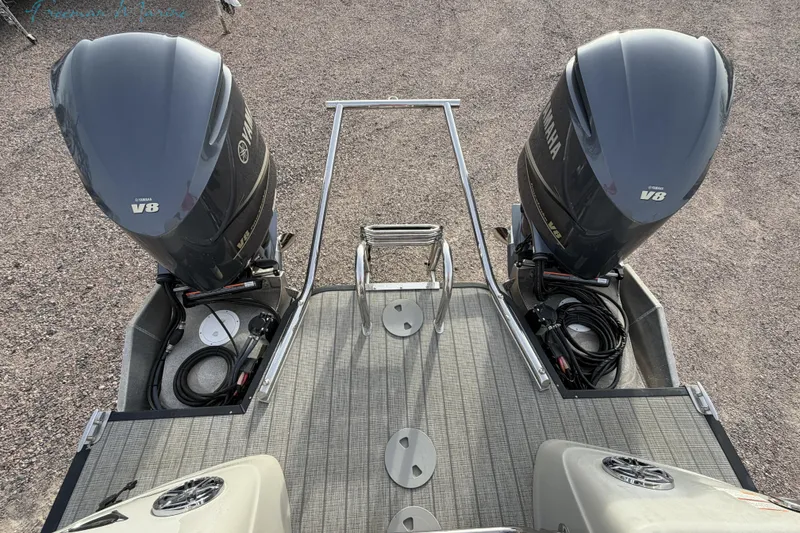 Slide: The Image of 2022 Manitou 27 LX SRW boat with dual Yamaha V8 engines, rear deck view. - 2
