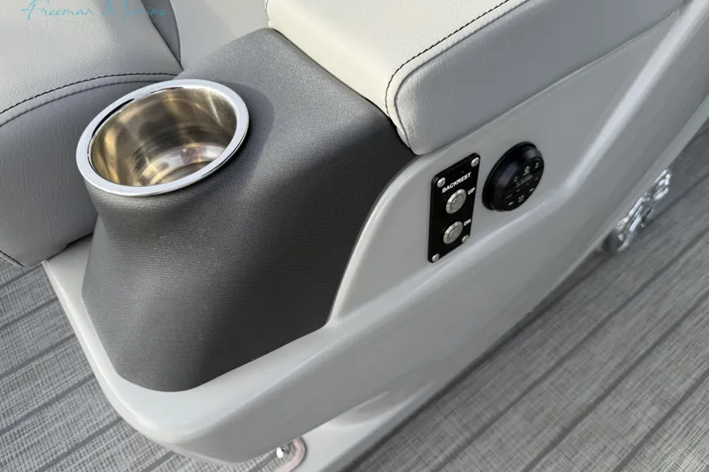 Slide: The Image of Cup holder and controls on 2022 Manitou 27 LX SRW boat seat. - 23