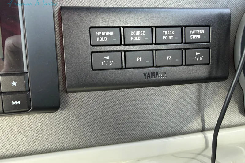 Slide: The Image of Control panel of a 2022 Manitou 27 LX SRW boat with Yamaha navigation buttons. - 29