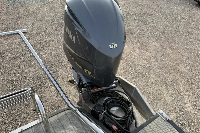 Slide: The Image of 2022 Manitou 27 LX SRW with Yamaha V8 outboard engine on gravel surface. - 30