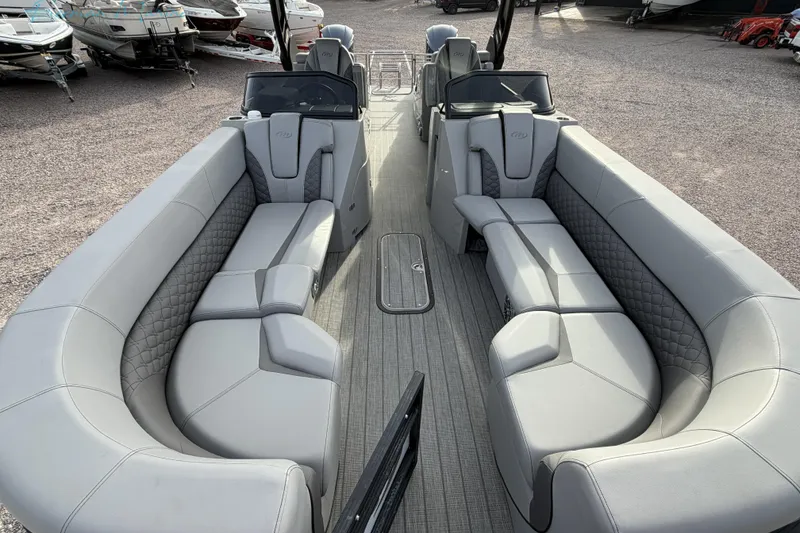Slide: The Image of 2022 Manitou 27 LX SRW pontoon boat with luxurious gray seating and spacious layout. - 8