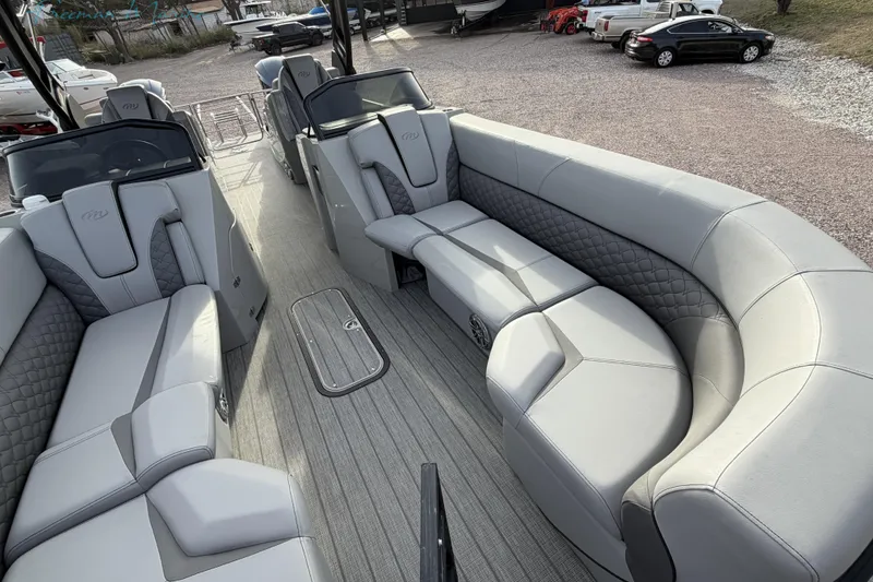Slide: The Image of Luxurious interior of 2022 Manitou 27 LX SRW pontoon boat with plush seating. - 9