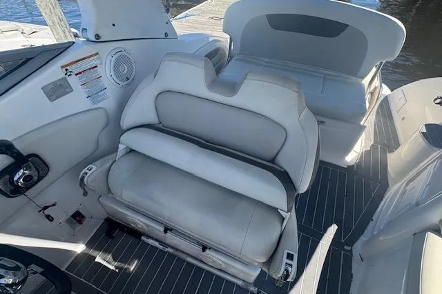 Slide: The Image of 2011 Chaparral 270 Signature boat interior with white seating and modern dashboard. - 11