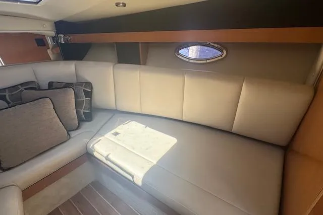 Slide: The Image of Interior of 2011 Chaparral 270 Signature boat with beige seating and decorative pillows. - 14