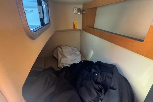 Slide: The Image of Interior cabin of 2011 Chaparral 270 Signature boat with bedding and window. - 16