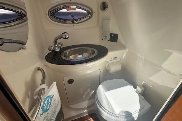 Slide: The Image of 2011 Chaparral 270 Signature boat bathroom with sink and toilet. - 18