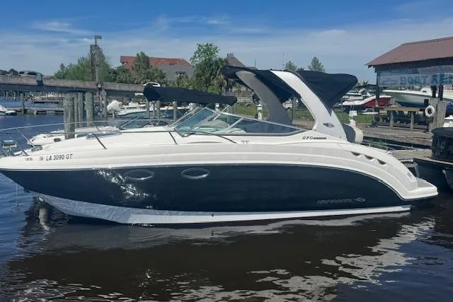 Slide: The Image of 2011 Chaparral 270 Signature boat docked at a marina under a clear blue sky. - 4