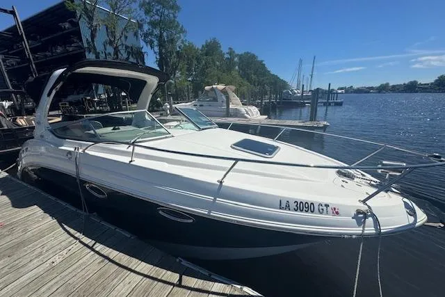 Slide: The Image of 2011 Chaparral 270 Signature boat docked by a serene waterfront. - 7