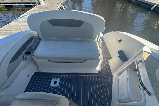 Slide: The Image of 2011 Chaparral 270 Signature boat interior with seating and deck view at dock. - 8