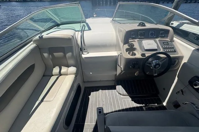 Slide: The Image of 2011 Chaparral 270 Signature boat cockpit with steering wheel and seating area. - 9